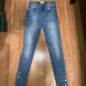 Light-medium wash high-rise jeans with ankle buttons